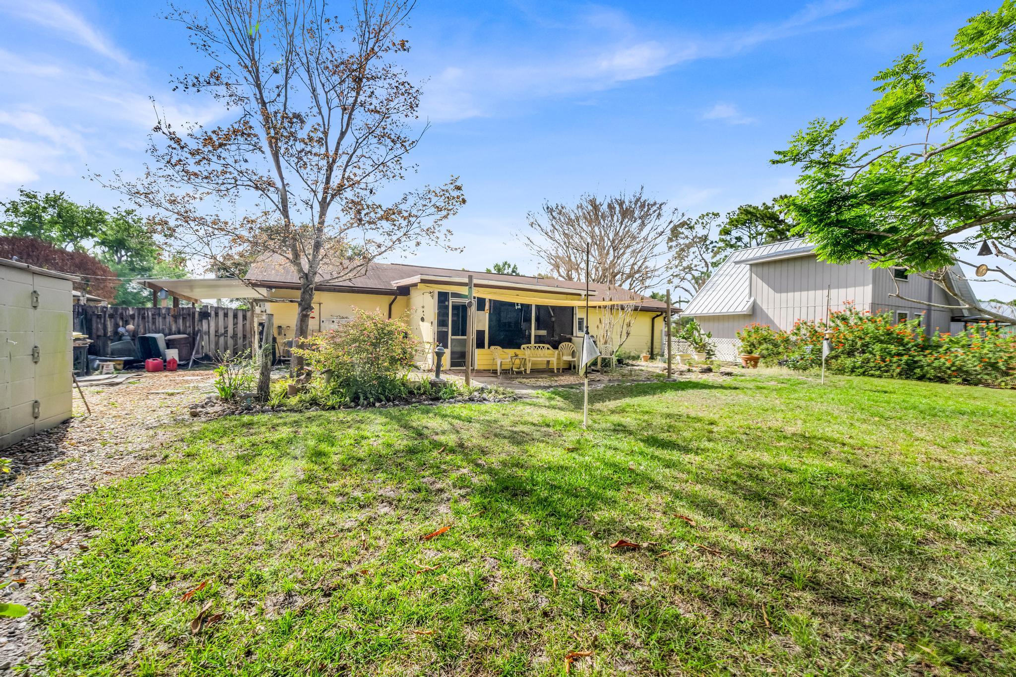 5406 Sunset Boulevard Fort Pierce, FL 34982 - Photo 28 of 33 a front view of a house with a yard