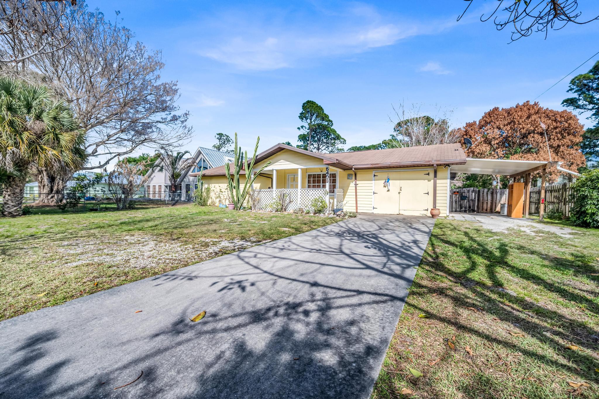 5406 Sunset Boulevard Fort Pierce, FL 34982 - Photo 30 of 33 a view of a house with a yard