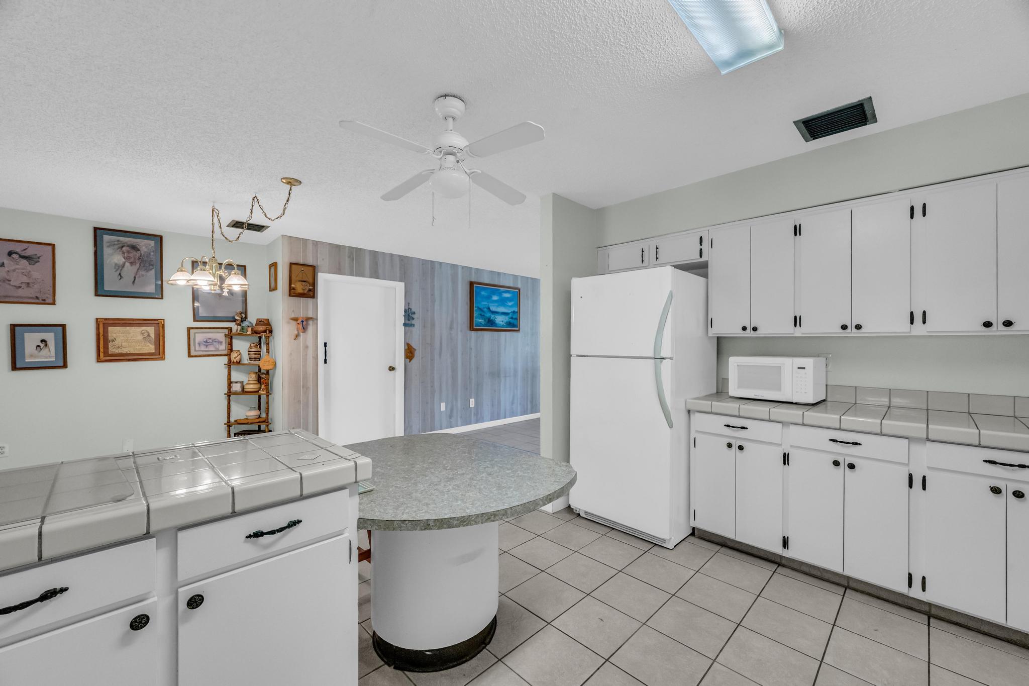 5406 Sunset Boulevard Fort Pierce, FL 34982 - Photo 8 of 33 a kitchen with cabinets and stainless steel appliances