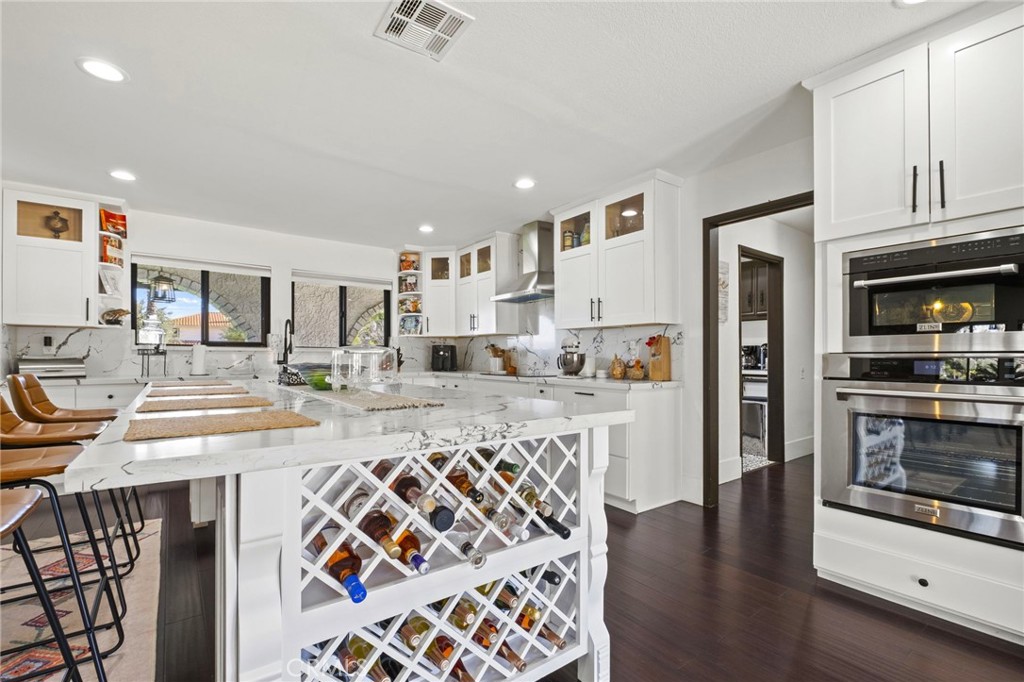 7710 Broadacre Place Riverside, CA 92504 - Photo 17 of 65 a kitchen with stainless steel appliances granite countertop a stove and a refrigerator