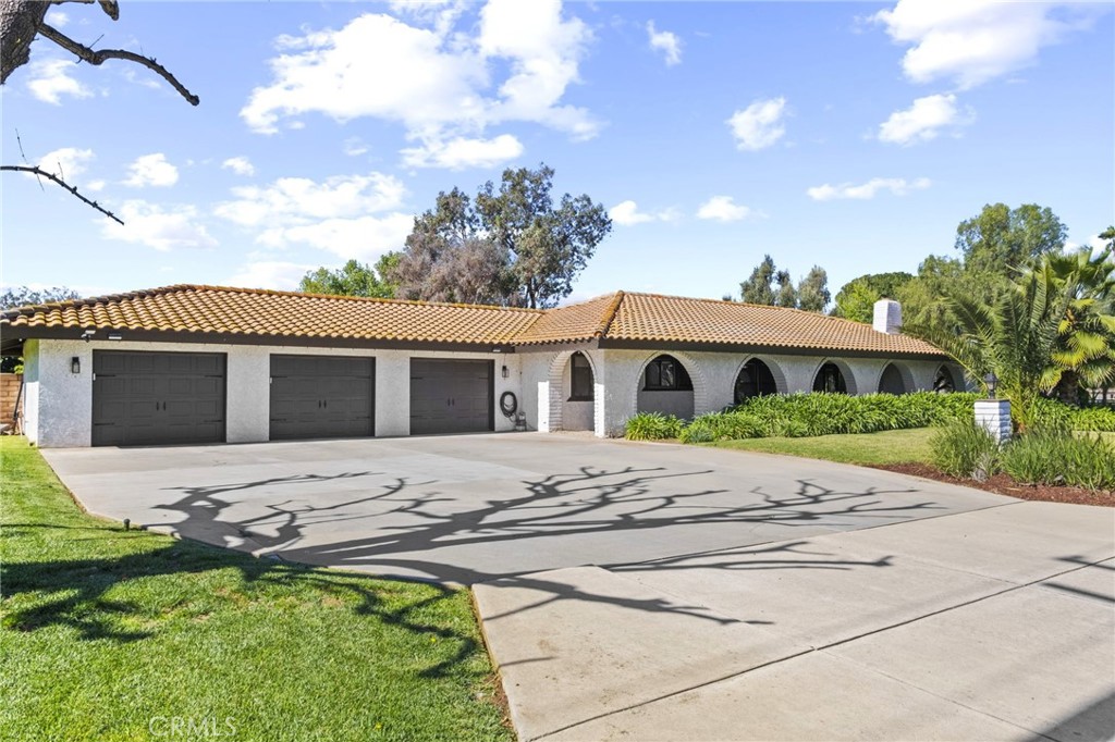 7710 Broadacre Place Riverside, CA 92504 - Photo 2 of 65 a front view of a house with a garden