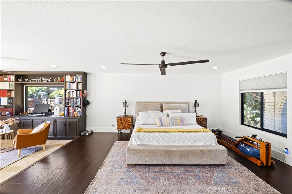 7710 Broadacre Place Riverside, CA 92504 - Photo 22 of 65 a spacious bedroom with a bed a couch and a large window