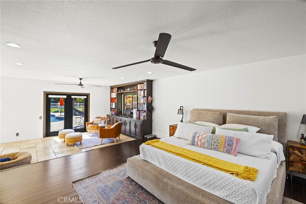 7710 Broadacre Place Riverside, CA 92504 - Photo 23 of 65 a bedroom with a bed couch and wooden floor