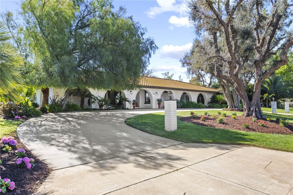 7710 Broadacre Place Riverside, CA 92504 - Photo 3 of 65 a front view of a house with a yard and trees