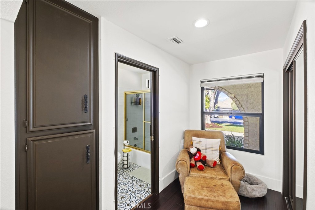 7710 Broadacre Place Riverside, CA 92504 - Photo 31 of 65 a living room with furniture and a painting on the wall