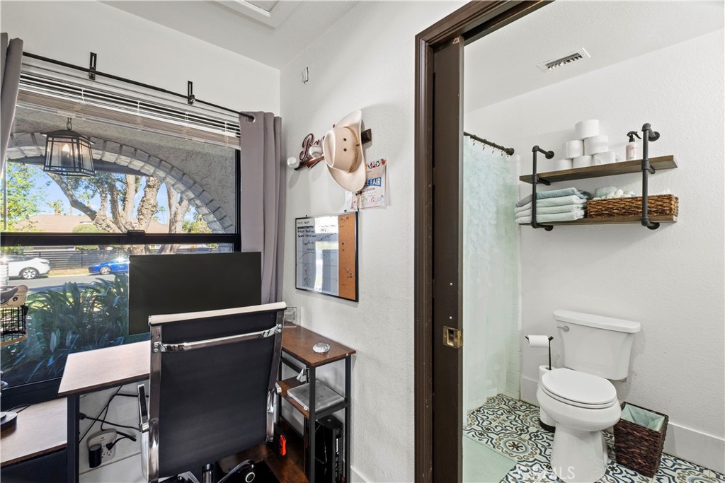 7710 Broadacre Place Riverside, CA 92504 - Photo 33 of 65 a bathroom with a toilet a sink and a mirror