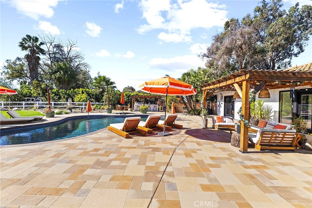 7710 Broadacre Place Riverside, CA 92504 - Photo 39 of 65 a view of a swimming pool with sitting area and furniture