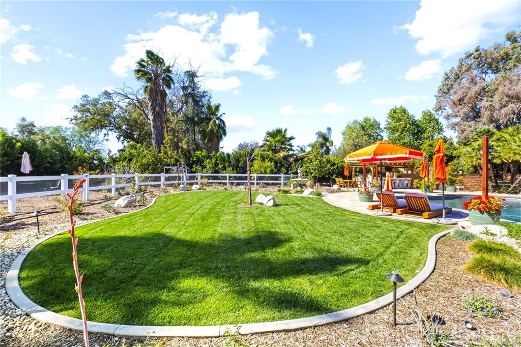 7710 Broadacre Place Riverside, CA 92504 - Photo 45 of 65 a view of a swimming pool with a garden and trees