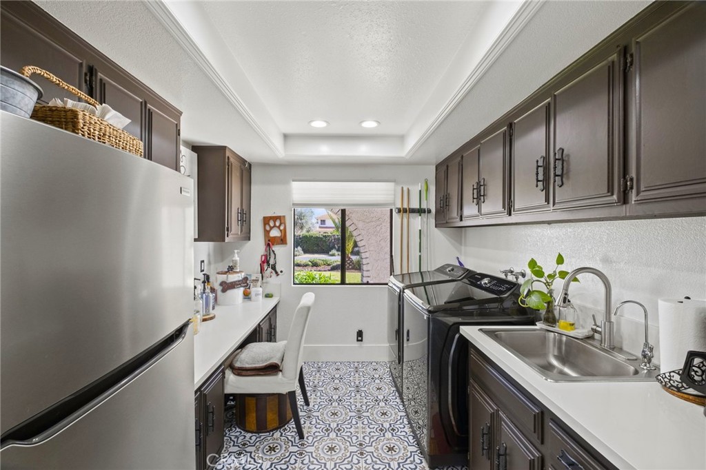 7710 Broadacre Place Riverside, CA 92504 - Photo 46 of 65 a kitchen with a sink stove and cabinets