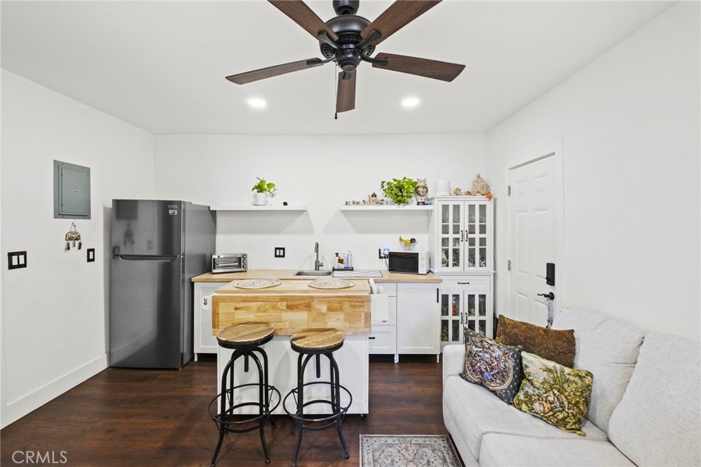 7710 Broadacre Place Riverside, CA 92504 - Photo 48 of 65 a living room with stainless steel appliances furniture a dining table and a refrigerator