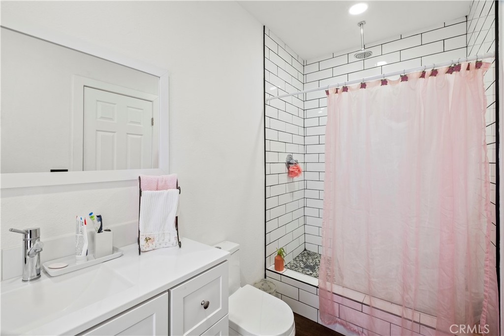 7710 Broadacre Place Riverside, CA 92504 - Photo 50 of 65 a bathroom with a sink a toilet and shower
