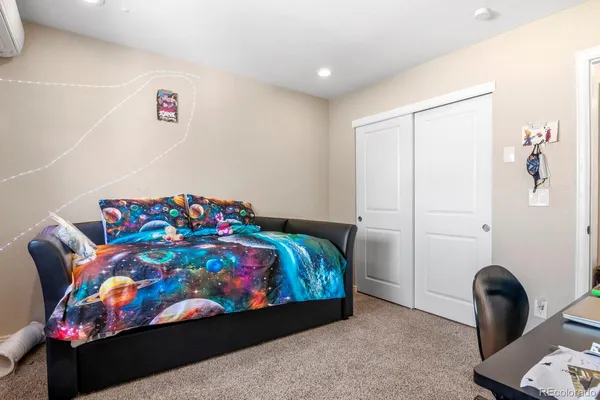 a bedroom with a bed and a painting on the wall