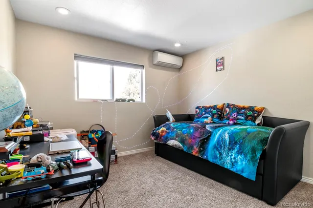 a bedroom with furniture and a wooden floor