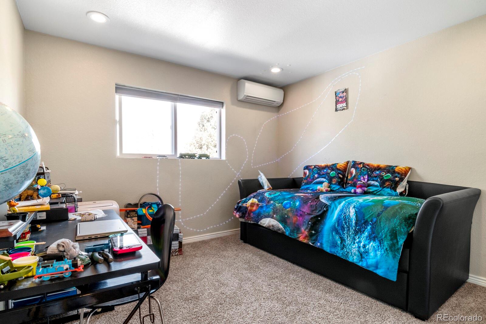 1065 Modred Street Lafayette, CO 80026 - Photo 22 of 34 a bedroom with furniture and a wooden floor