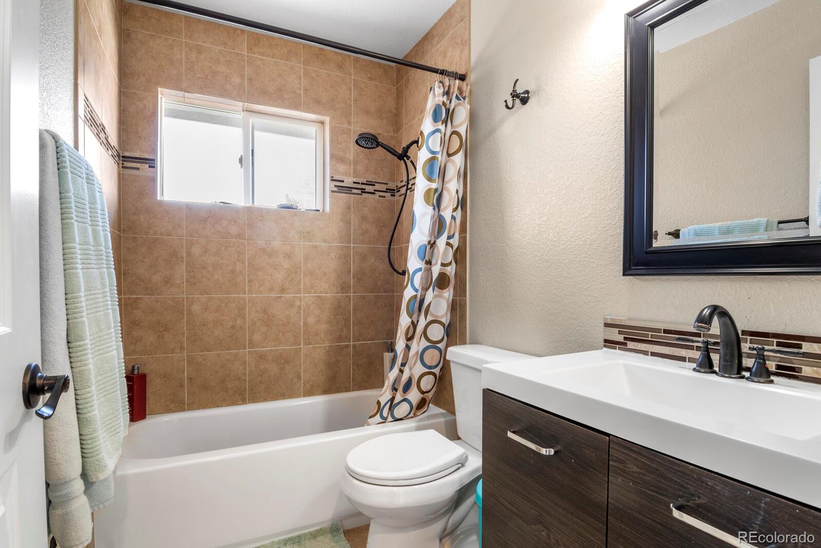 1065 Modred Street Lafayette, CO 80026 - Photo 23 of 34 a bathroom with a sink a toilet and a bathtub
