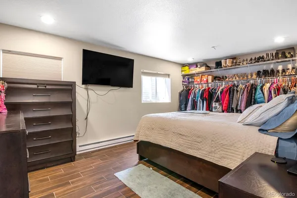 a bed room with a bed and a television