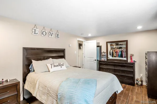 a bedroom with a bed and wooden floor