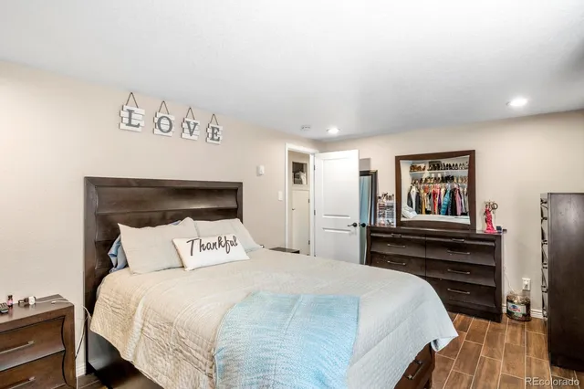 a bedroom with a bed and wooden floor