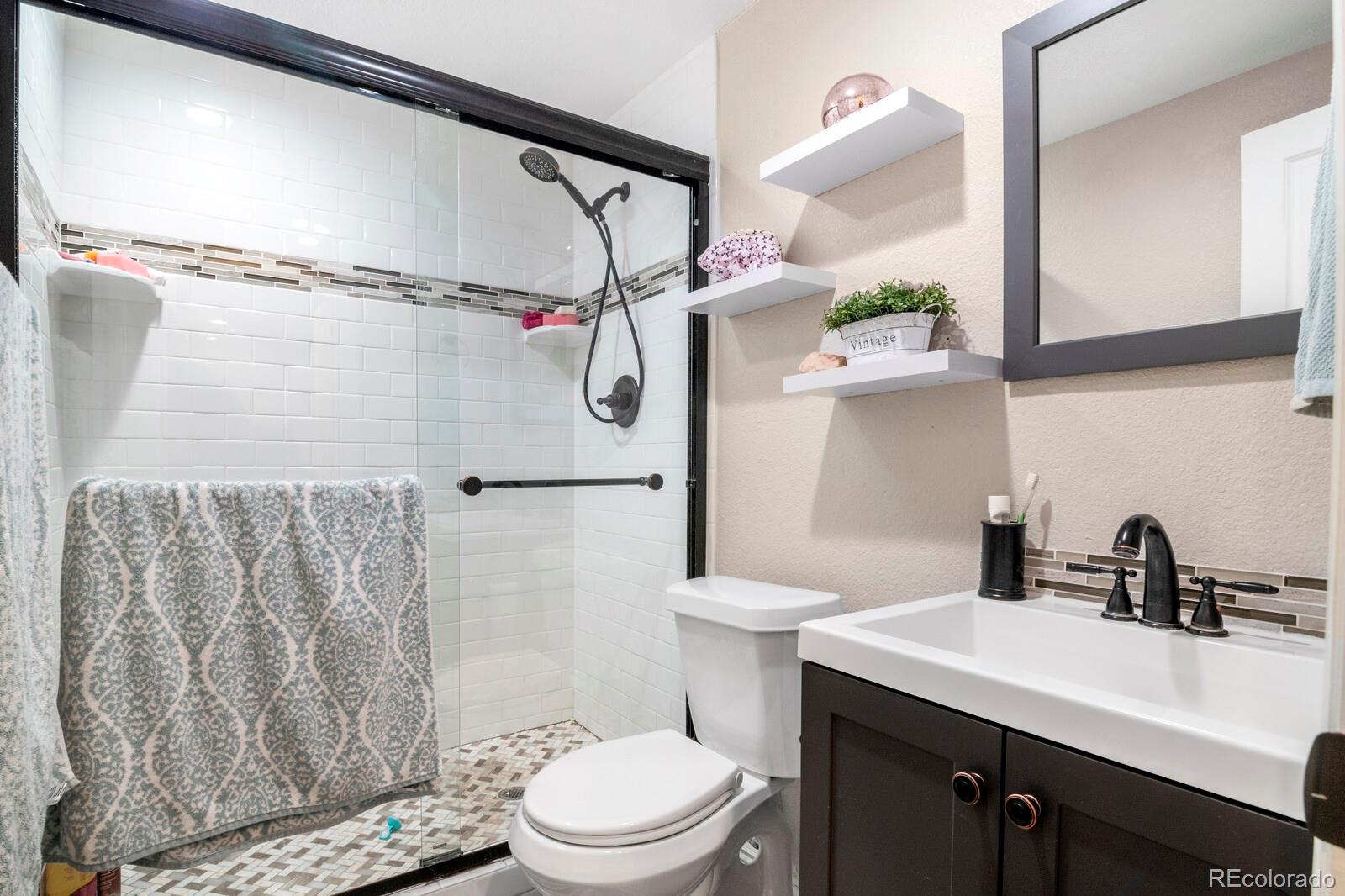 1065 Modred Street Lafayette, CO 80026 - Photo 27 of 34 a bathroom with a sink a toilet and shower