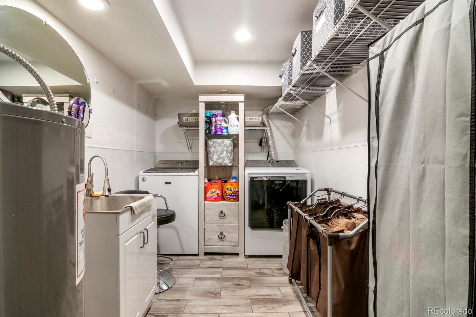 1065 Modred Street Lafayette, CO 80026 - Photo 28 of 34 a storage room with washer and dryer