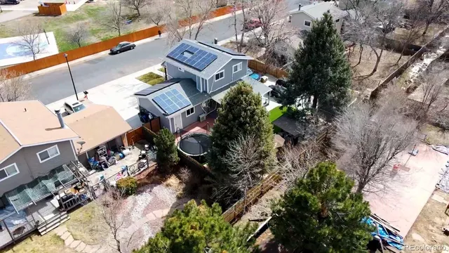 an aerial view of a house with garden space and street view