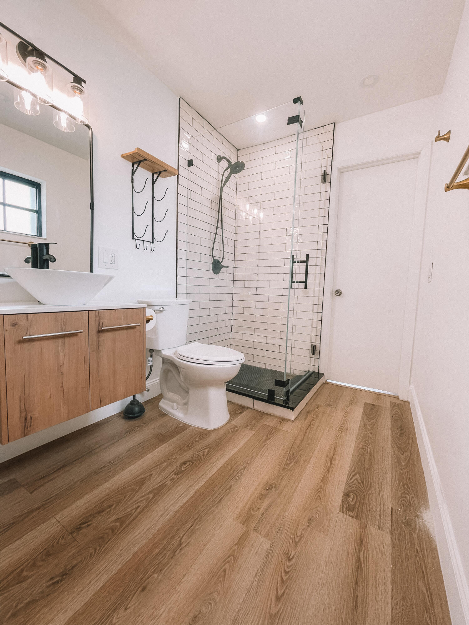 2171 Northeast 44th Court Lighthouse Point, FL 33064 - Photo 22 of 24 a bathroom with a sink a toilet a mirror and shower