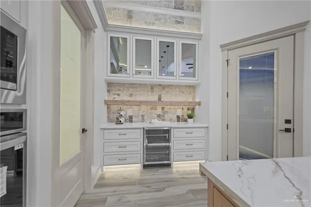 a view of kitchen with stainless steel appliances cabinets and wooden floor
