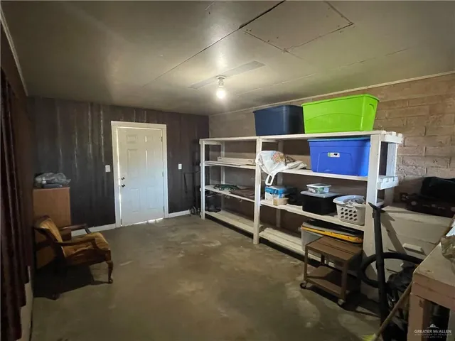 a room with furniture gym equipment and a window