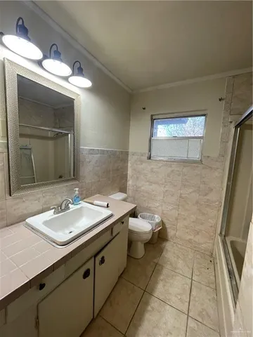 a bathroom with a sink a toilet and mirror