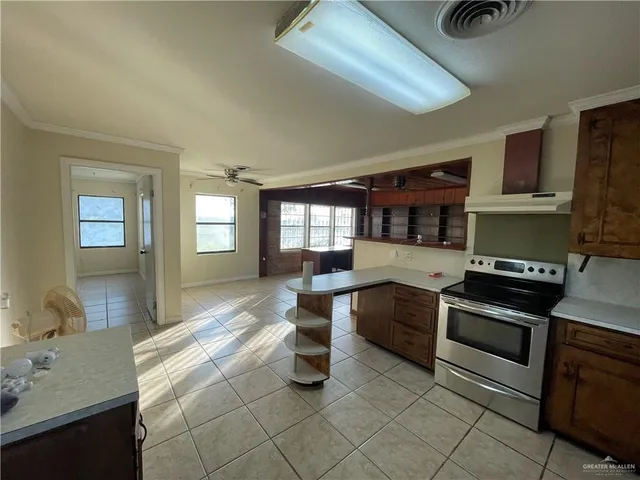 a large kitchen with a stove and cabinets