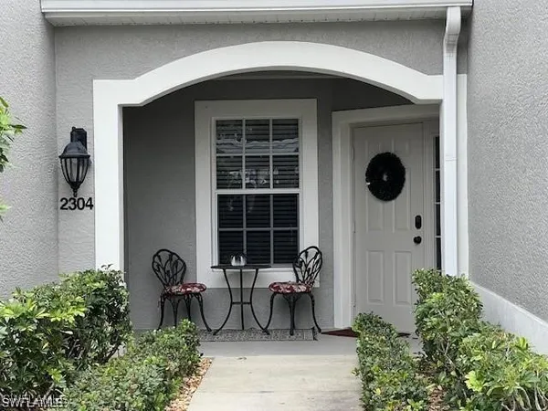 a front view of a house with outdoor seating and plants