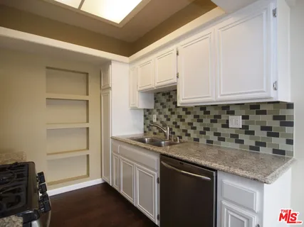 a kitchen with cabinets appliances and a counter space