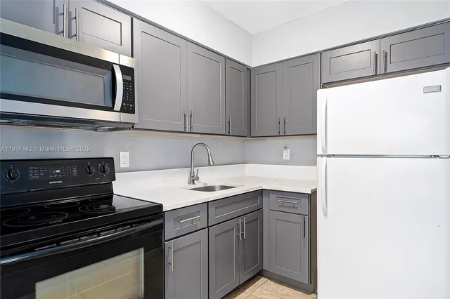 a kitchen with a stove and white cabinets