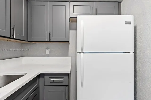 a view of an empty room with window and a bathroom
