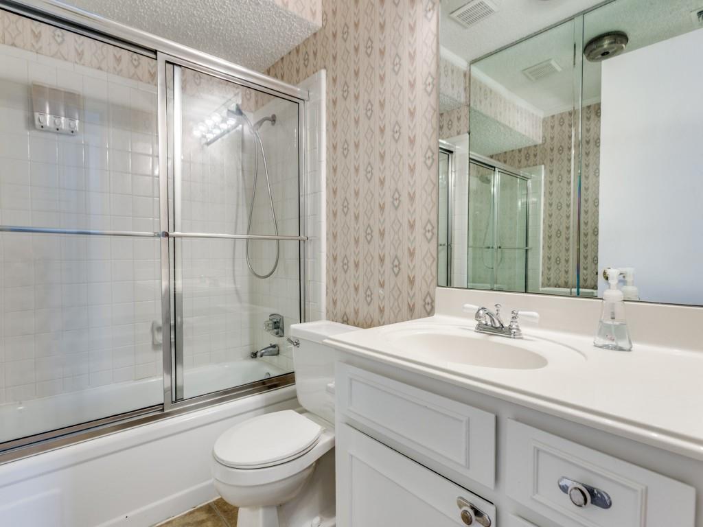 1216 Manning Street Benbrook, TX 76126 - Photo 16 of 26 Bathroom featuring enclosed tub / shower combo, vanity, a textured ceiling, wallpapered walls, and tile patterned floors
