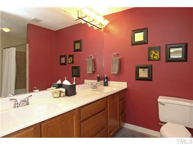 6413 Rushingbrook Drive Raleigh, NC 27612 - Photo 11 of 24 a bathroom with a sink a toilet and mirror