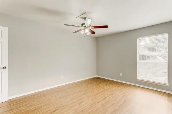 wooden floor in an empty room with a window