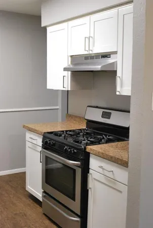 a stove top oven sitting inside of a kitchen