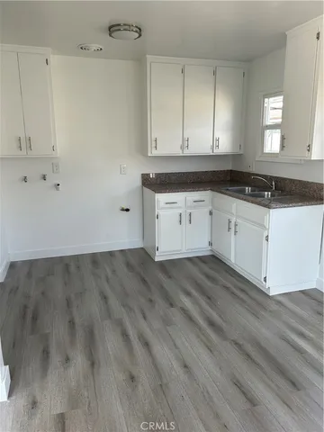 a view of a kitchen with wooden floor