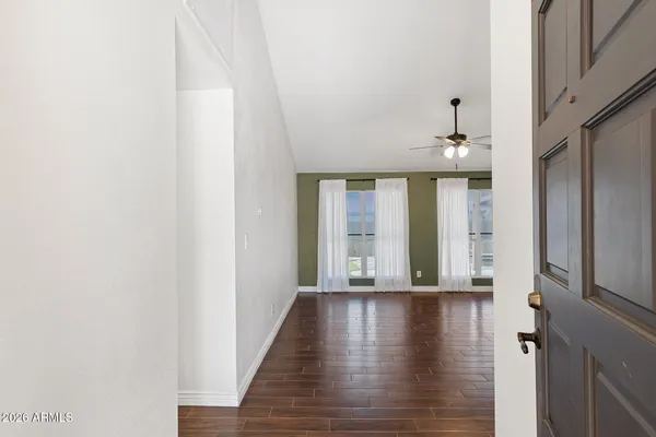 a view of an entryway with wooden floor