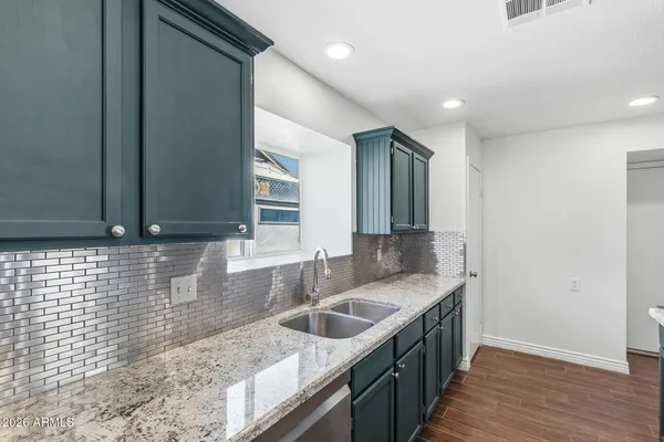 a kitchen with a sink and a stove top oven