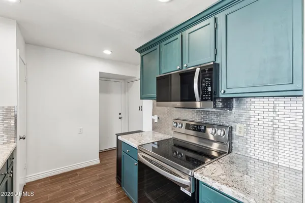 a kitchen with a stove and a microwave