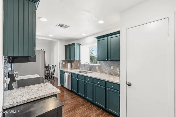 a large bathroom with a granite countertop sink a toilet a mirror and vanity