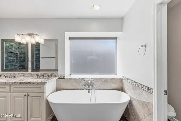 a bathroom with a bathtub and a sink