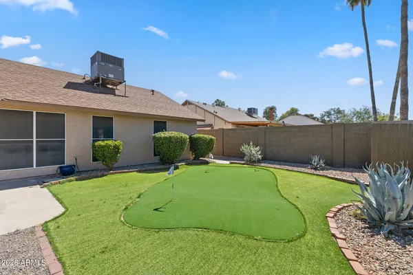 a view of a house with pool and a yard