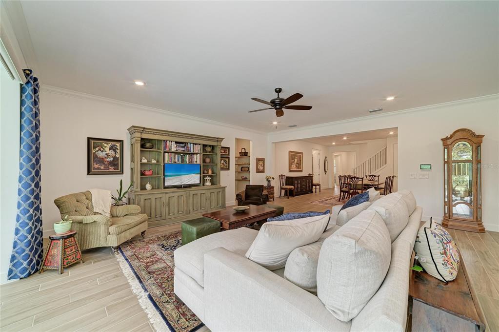 16341 Hidden Oak Loop Lakewood Ranch, FL 34211 - Photo 13 of 76 a living room with furniture and a flat screen tv