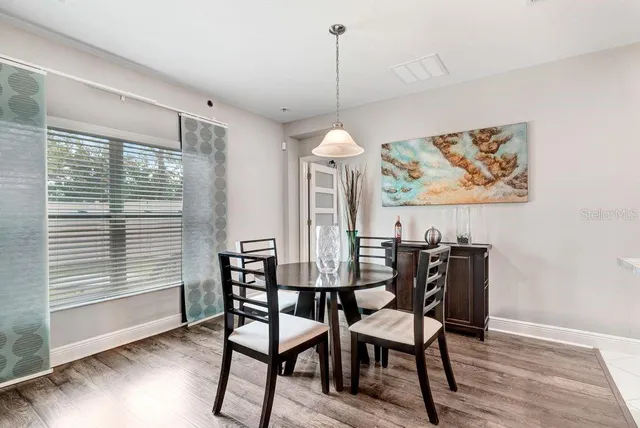 a view of a dining room with furniture window and wooden floor