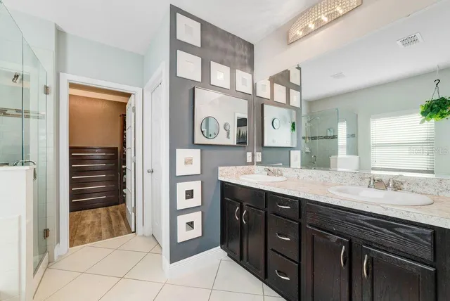 a spacious bathroom with a granite countertop sink and a mirror