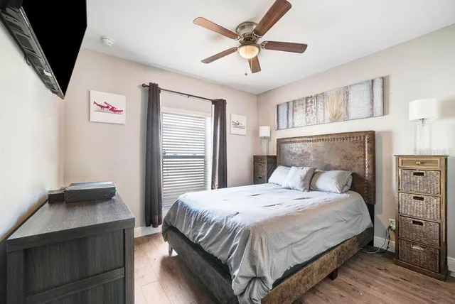 a bedroom with a bed and a ceiling fan