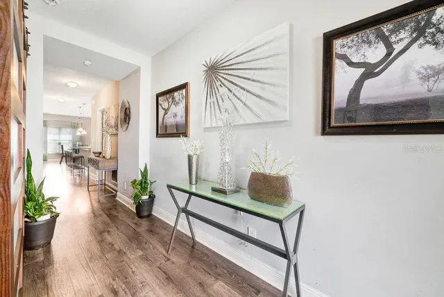 a living room with furniture and a painting on the wall